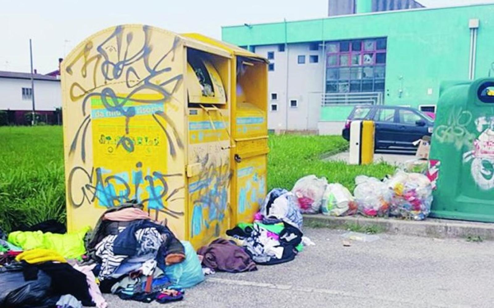 Cassonetti rovesciati, vestiti rubati