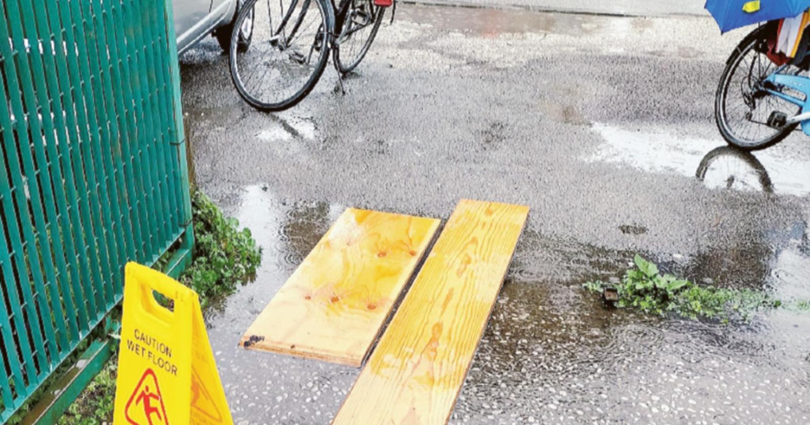 La pioggia allaga le strade e bambini sulle tavole