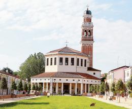 Piazza a lucido tra lecci, rose e prato